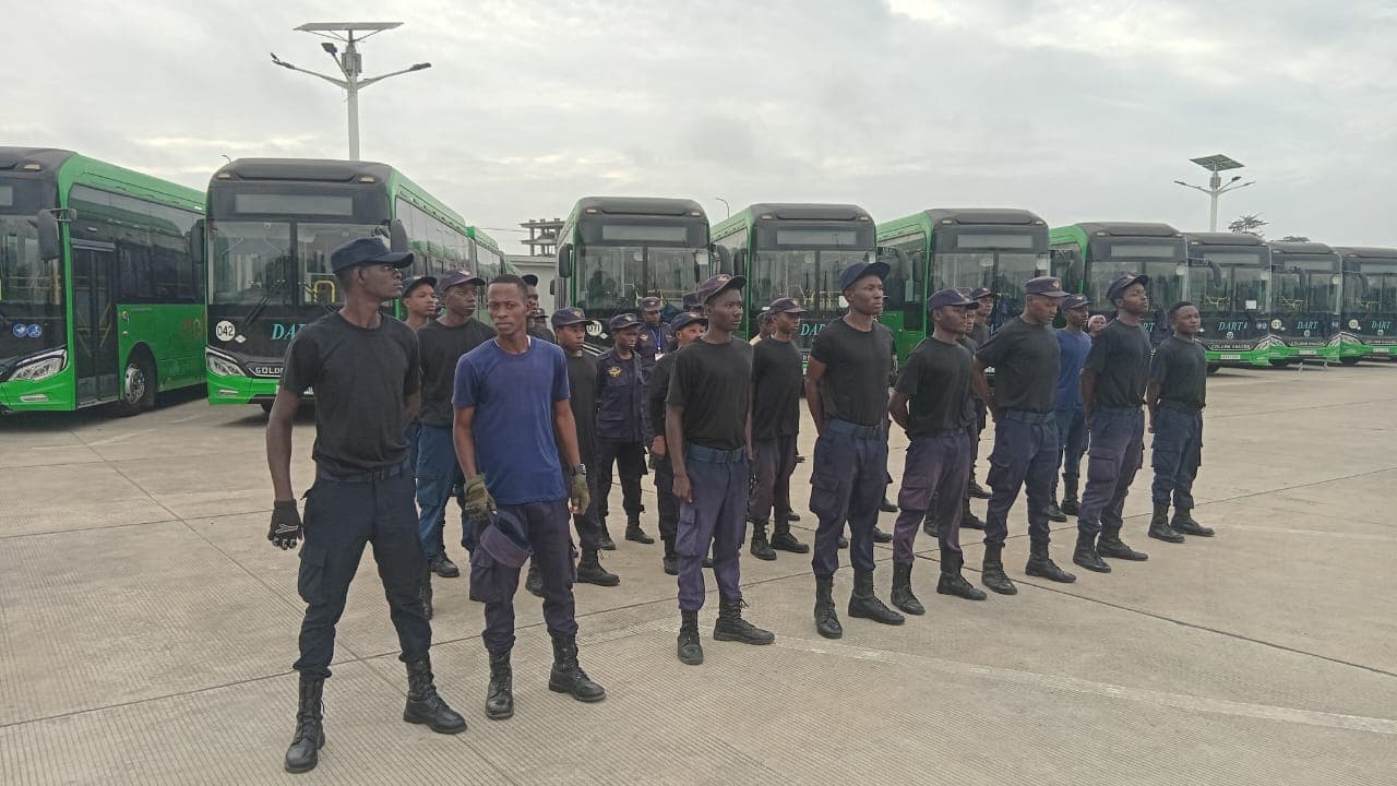 Second view of HKB officers lined up beside DART buses