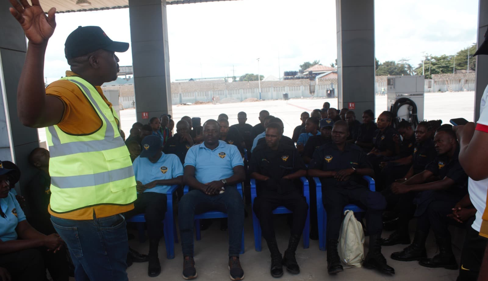 HKB officers standing to attention beside DART buses