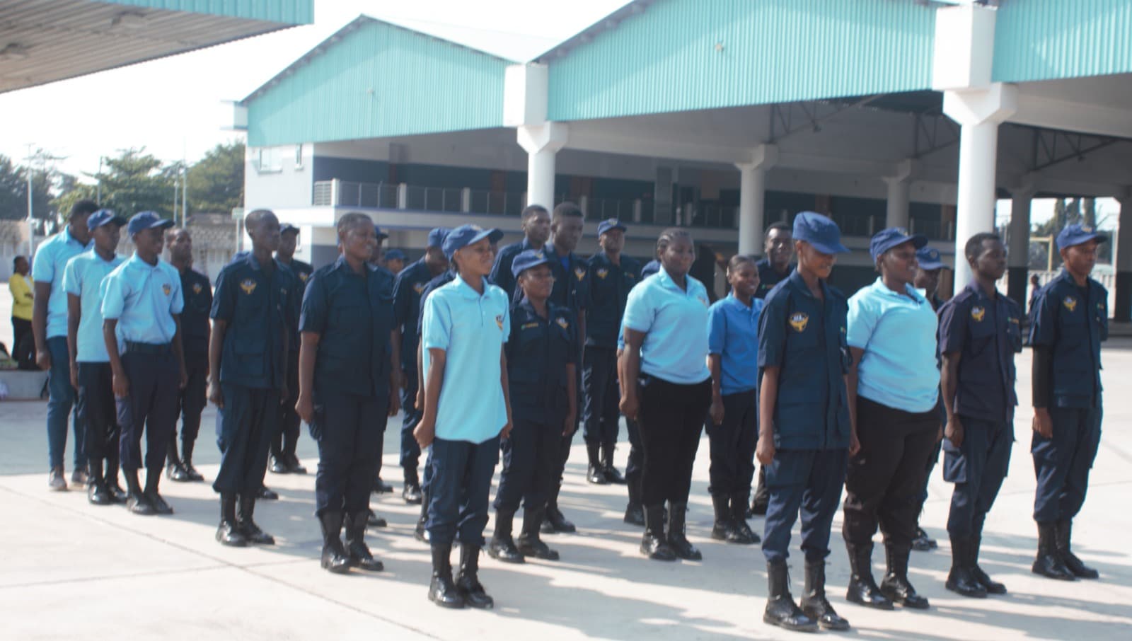 HKB officers lined up in front of green BRT buses